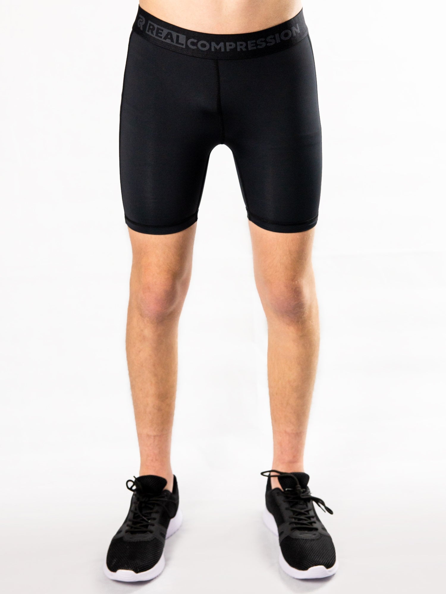 Black youth compression half shorts – front view